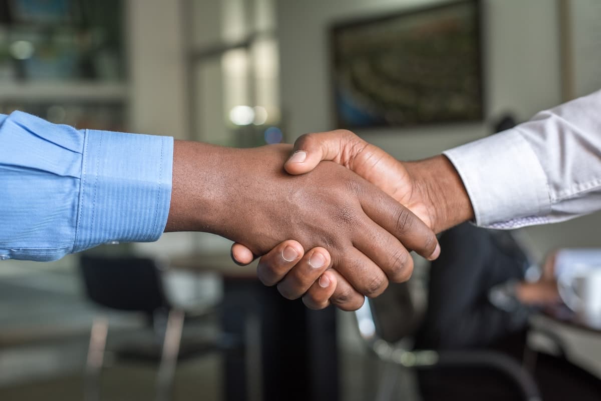 Two business partners shaking hands after closing a funding deal
